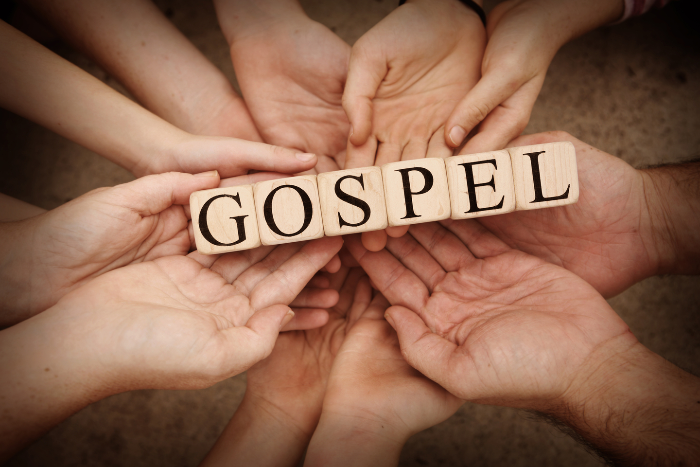 Team Holding Building Blocks spelling out Gospel