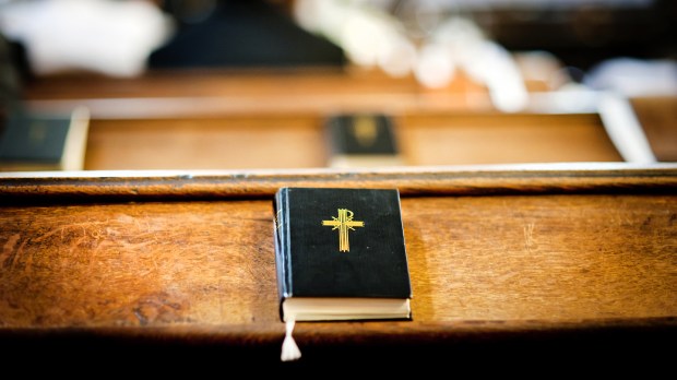 Still photo of bible put on wooden desk in church