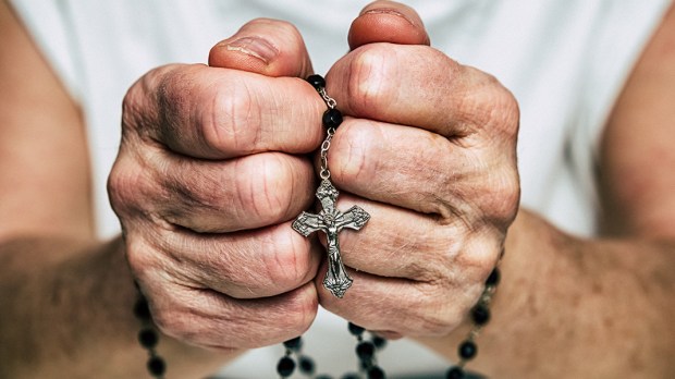 web3-man-hands-rosary-praying-jaroslav-moravcik-shutterstock