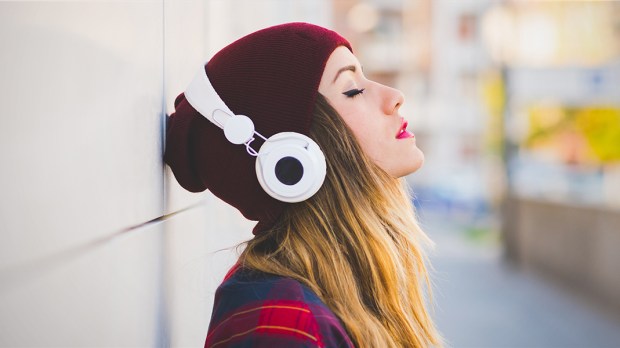 WEB3-YOUNG-WOMAN-LISTENING-MUSIC-HEADPHONES-Shutterstock