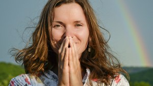 WEB3-WOMAN-RAINBOW-SKY-HANDS-FOLDED-GRATITUDE-Shutterstock