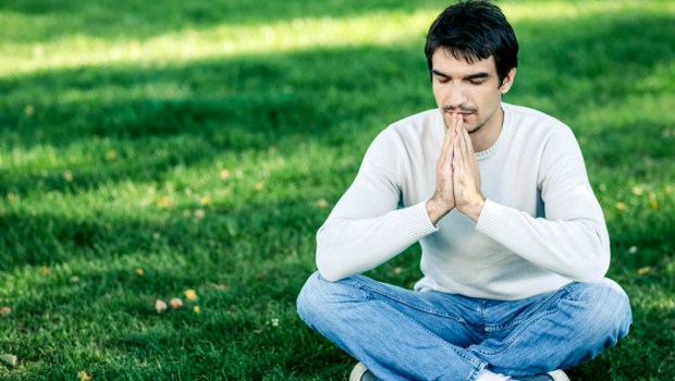 MAN MEDITATING IN PARK