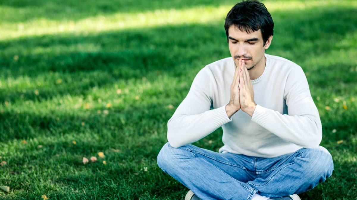 MAN MEDITATING IN PARK