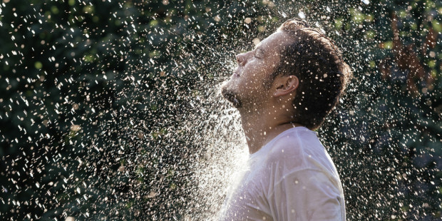 web3-young-handsome-man-in-white-t-shirt-having-shower-in-the-sunny-rain-at-the-summer-garden-shutterstock_307415330