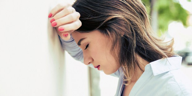 WOMAN LEANING ON WALL