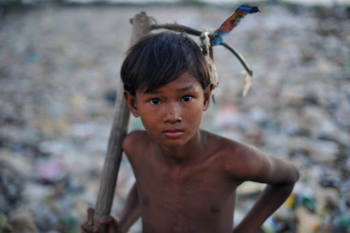 a Myanmar boy holding a tool &#8211; ar