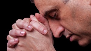 MATURE MAN PRAYING,