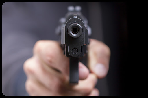 Man with gun © MyImages – Micha / Shutterstock