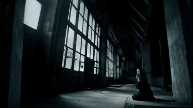 woman praying inside building