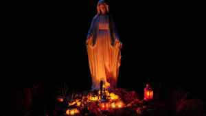 statue of a virgin mary lighted by candles