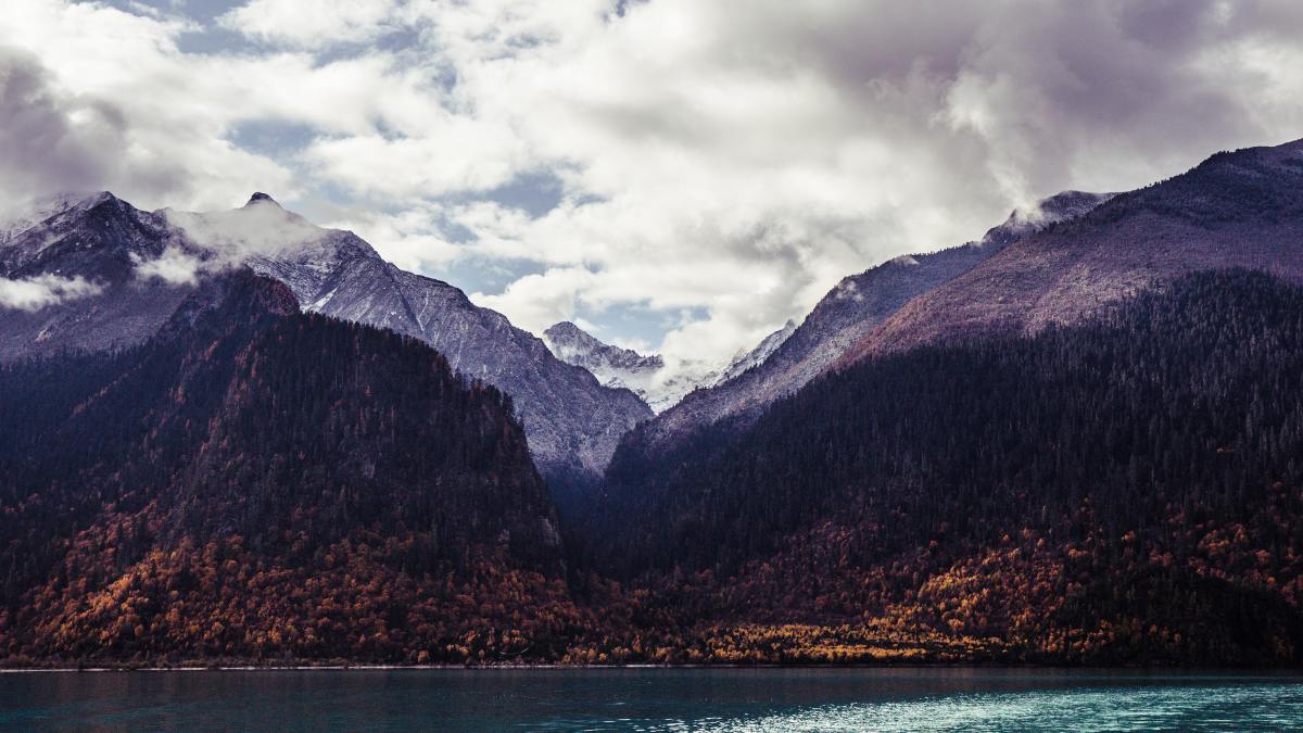 clouds over the mountains located by the lake