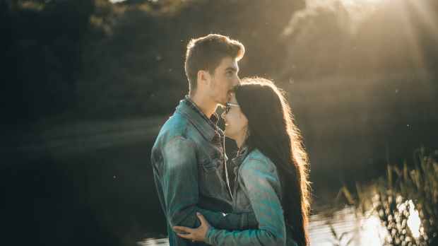 photo of man kissing woman s forehead