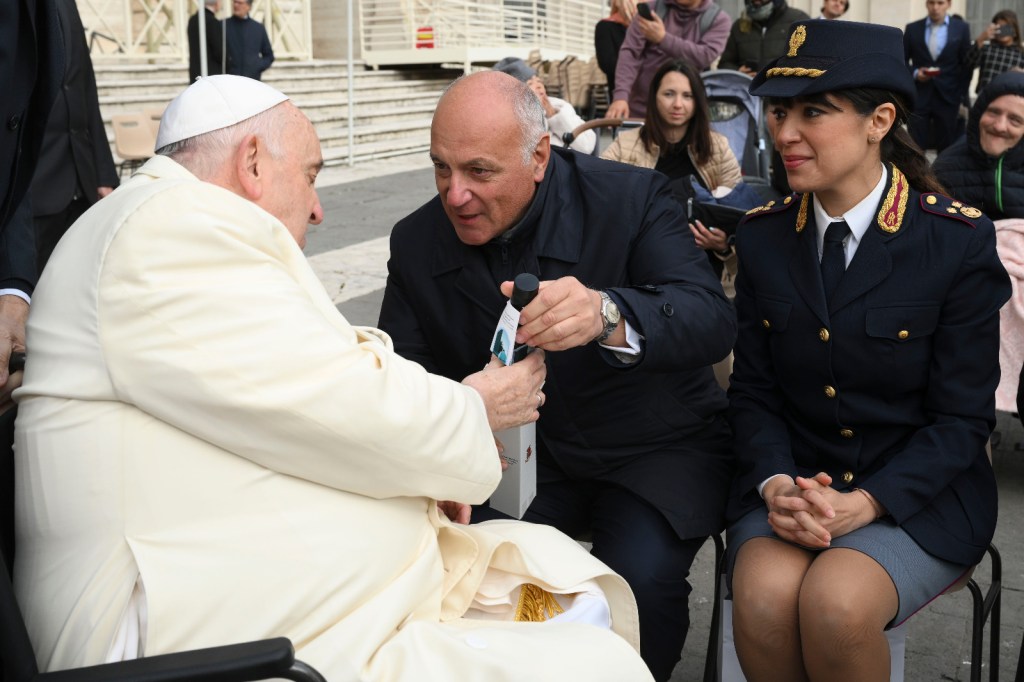 Rome's chief police commissioner gives Pope Francis a bottle of oil to be used in the chrism mass. The oil comes from a garden dedicated to Judge Giovanni Falcone and others who died in an attack by the Sicilian mafia.