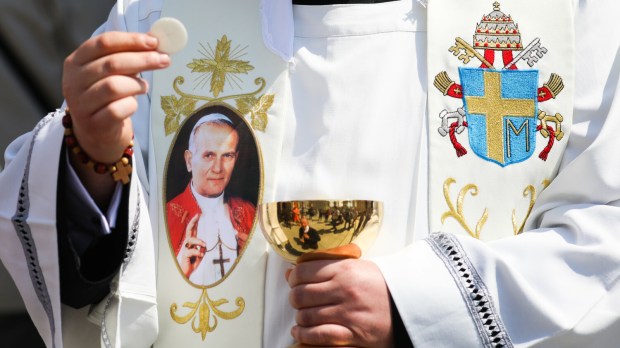 Jan Paweł II na stule księdza rozdającego Komunię świętą