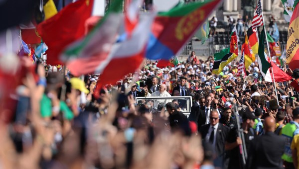 Pope Francis waves from the popemobile to pilgrims as he arrives for the welcoming ceremony of World Youth Day