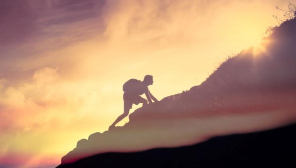 Man climbing up a mountain. Motivation, and inspiration concept