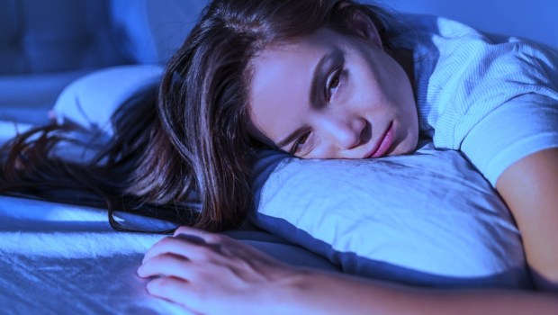 Young woman in bed cannot sleep
