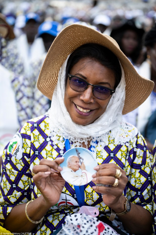 A Senegalese woman holds an icon of St. Pope John Paul II during Pope Francis' general audience in St. Peter's Square at the Vatican, August 28, 2024.