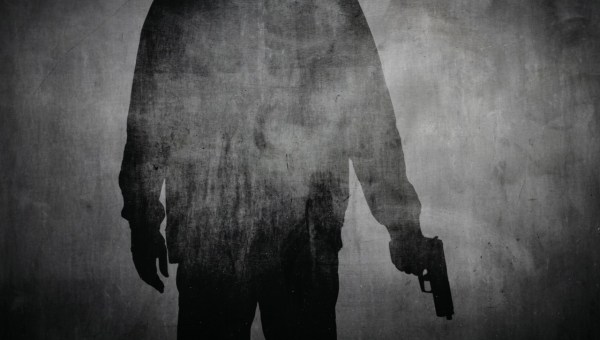Sylwetka mężczyzny z pistoletem