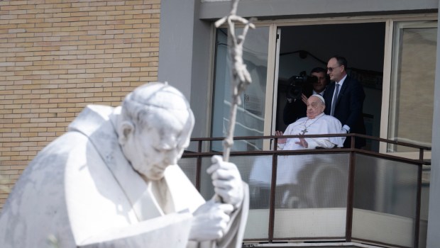 Pope Francis waves from a window of the Gemelli hospital before to be discharge after a five weeks hospitalization for pneumonia, in Rome on March 23, 2025