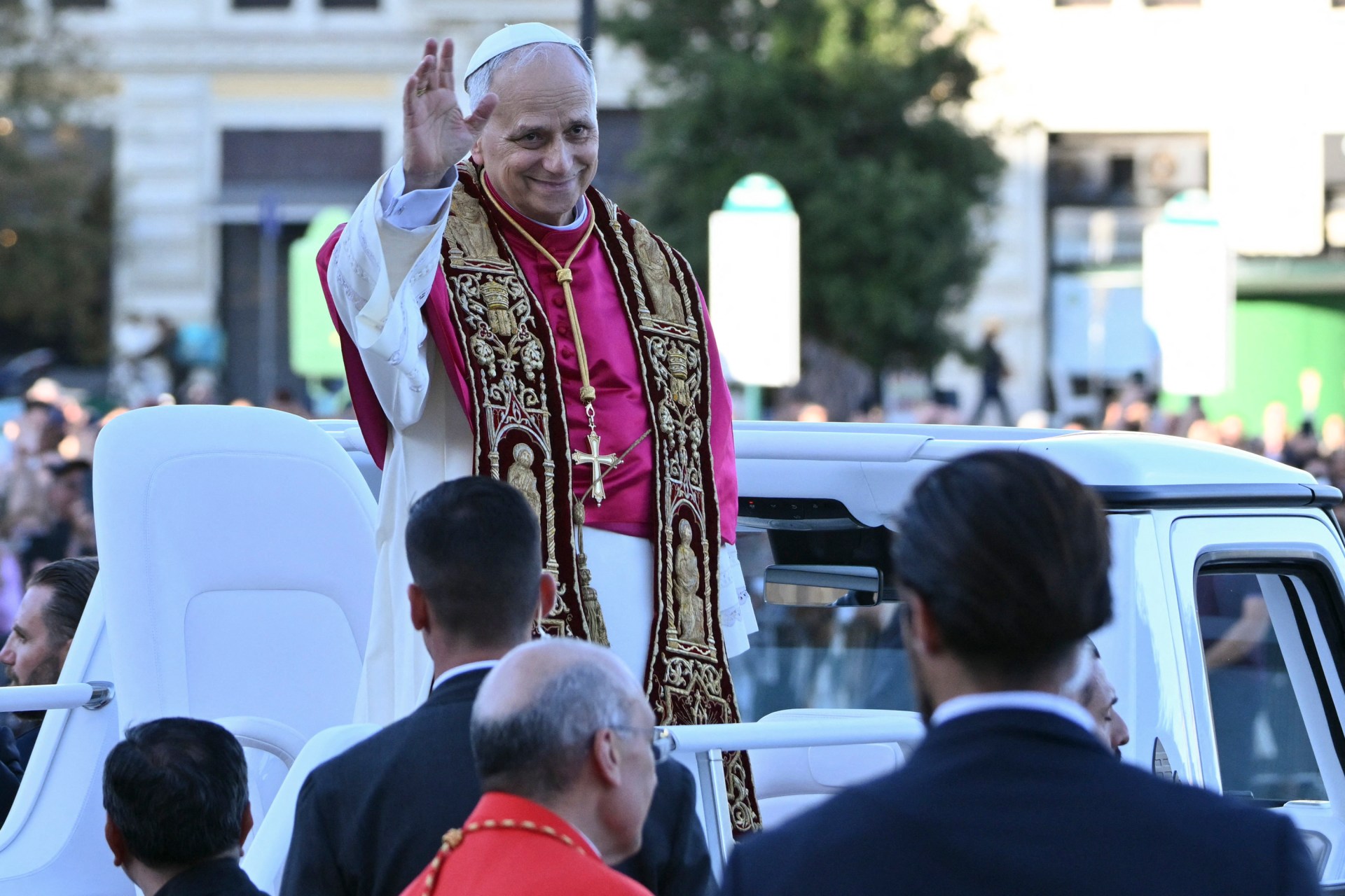Pope Leo XIV waves to the crowd from the popemobile as he leaves Saint John Lateran archbasilica after a holy mass in Rome, on May 25, 2025.