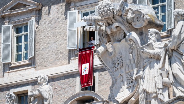 Pope Leo XIV blesses the crowd from a window of the apostolic palace overlooking St Peter's Square during the Angelus prayer in The Vatican on June 21, 2026.