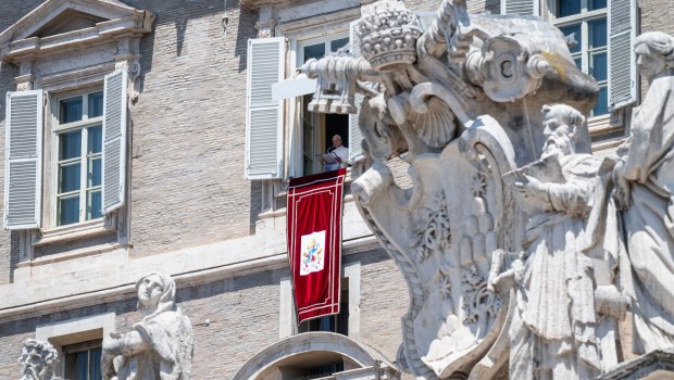 Pope Leo XIV blesses the crowd from a window of the apostolic palace overlooking St Peter's Square during the Angelus prayer in The Vatican on June 21, 2026.